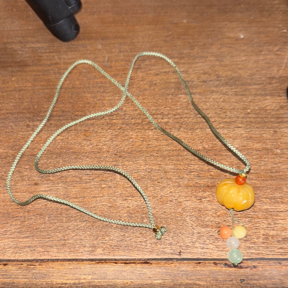 Fun pumpkin necklace - green string - bought to many. Have two available.